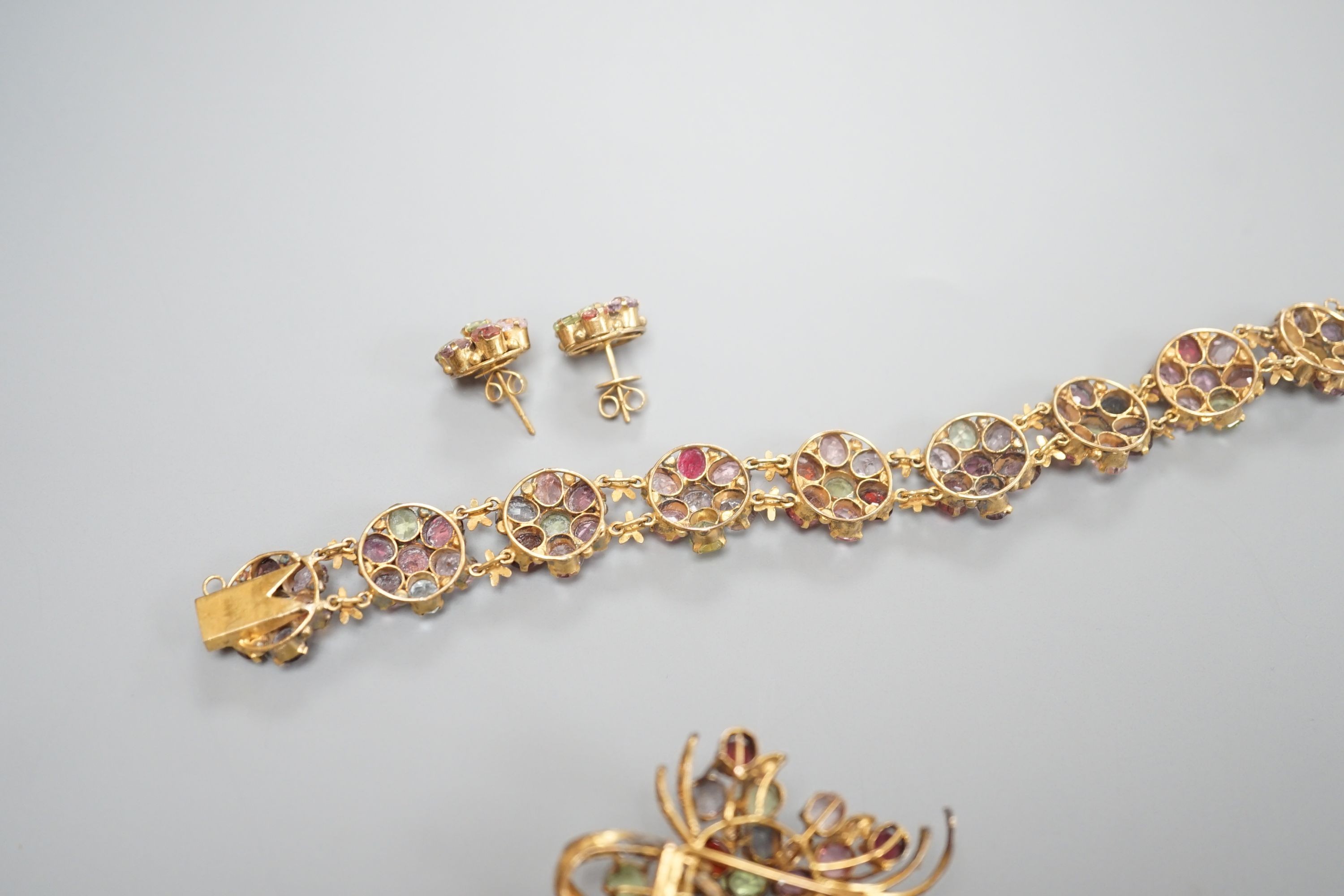 A gilt metal and coloured paste set bracelet and pair of earrings and a similar brooch, 6cm.